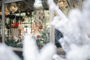 Woman creating Christmas decor arrangement in shop Woman creating Christmas decor arrangement in shop